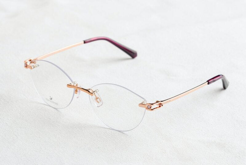 frameless eyeglasses on white surface