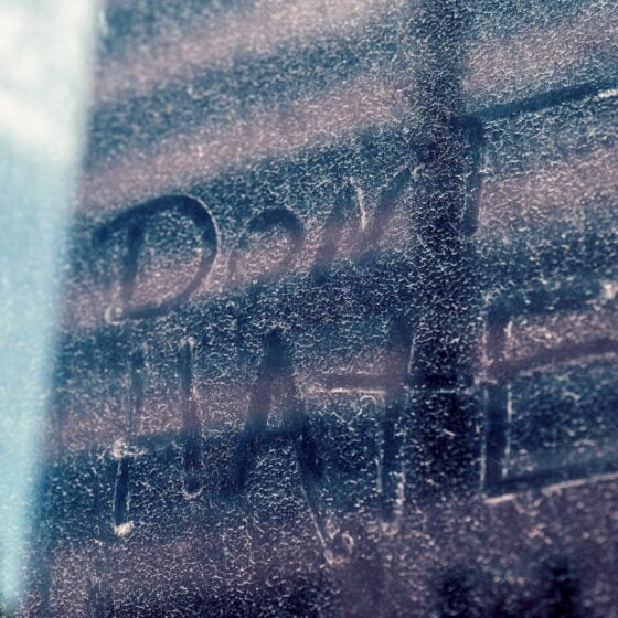 dont hate inscription on glass wall behind building