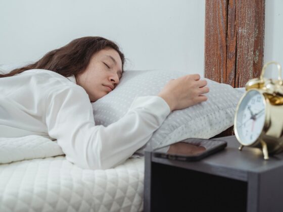young female sleeping on bed in morning