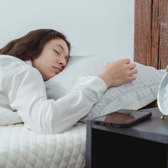 young female sleeping on bed in morning