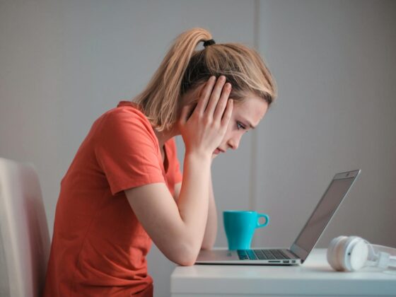 young troubled woman using laptop at home