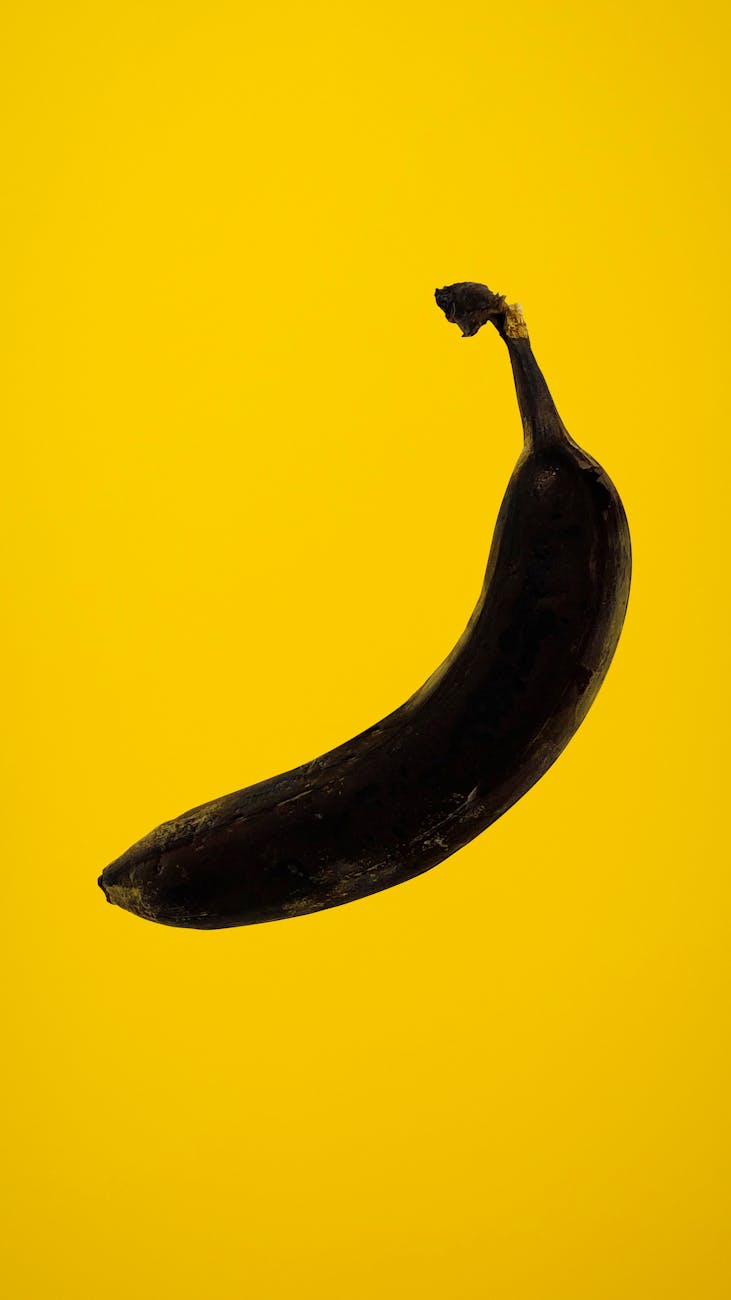 rotten banana on yellow background