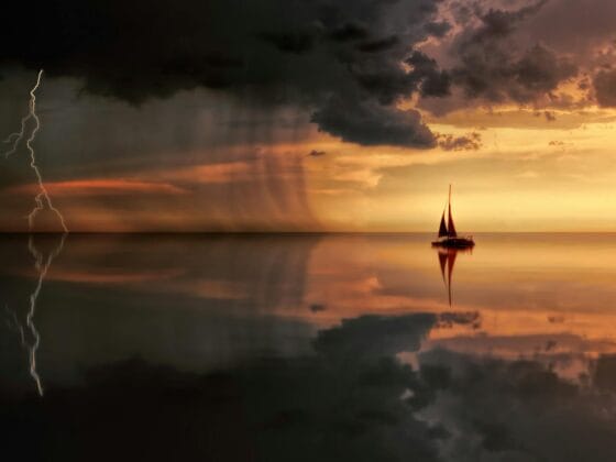 silhouette photography of boat on water during sunset
