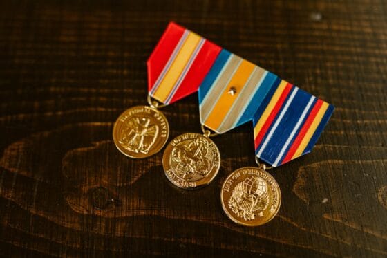 close up photo of medals on wooden surface