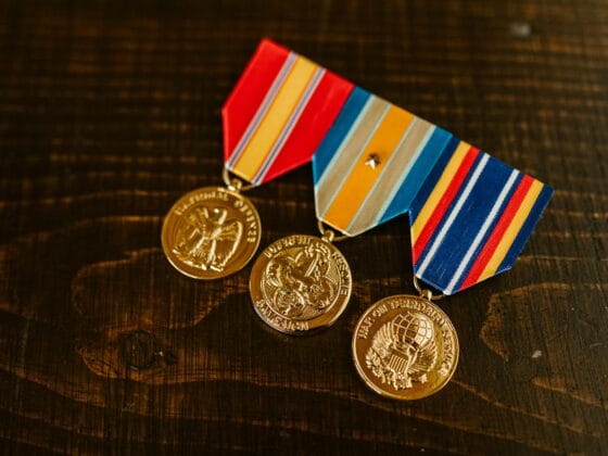 close up photo of medals on wooden surface