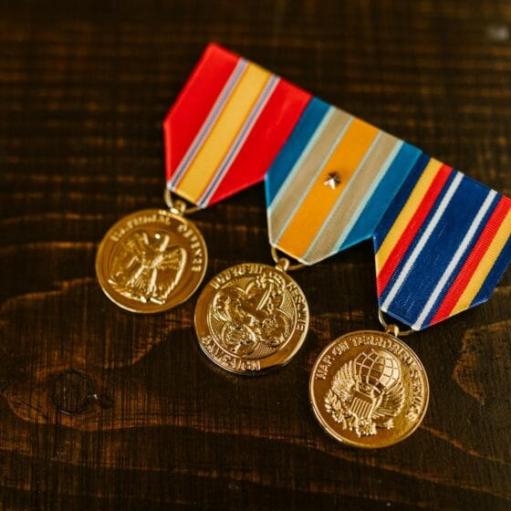 close up photo of medals on wooden surface