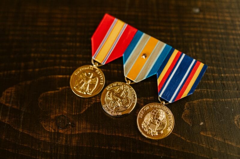 close up photo of medals on wooden surface