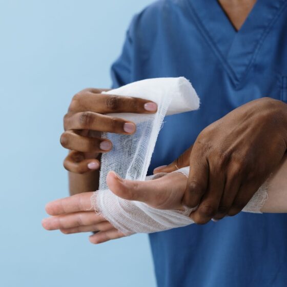 a person getting his hand bandaged