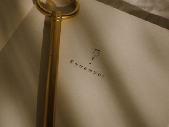 vintage key on open notebook with remember text