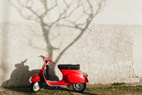 red motor scooter near wall