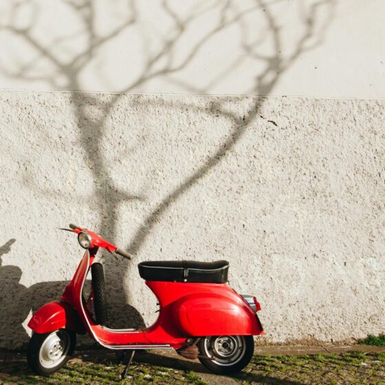 red motor scooter near wall