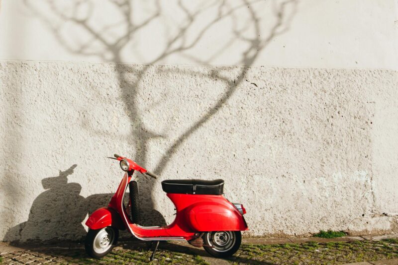 red motor scooter near wall