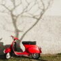 red motor scooter near wall