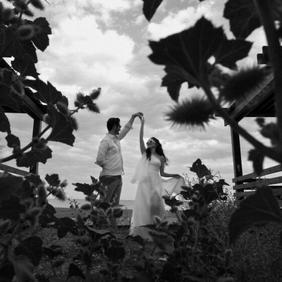A couple dances romantically among wild plants at an outdoor wedding in Antalya.