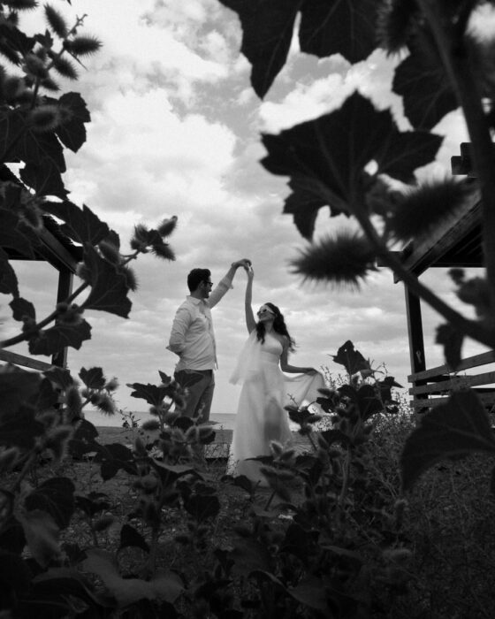 A couple dances romantically among wild plants at an outdoor wedding in Antalya.