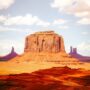 A large red sandstone butte rising above a desert landscape in Monument Valley.
